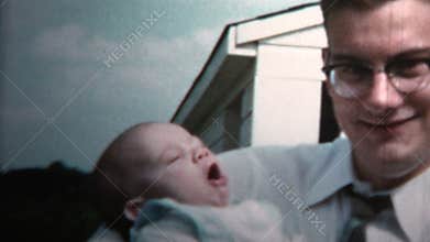 1958 - New Dad Holding Baby Versus Grandpa Holding Baby