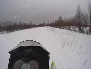 Snowmobile moves in a snowy field