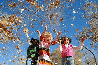 Girls playing with leaves