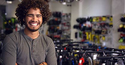 Portrait of mechanic standing with arms crossed in workshop