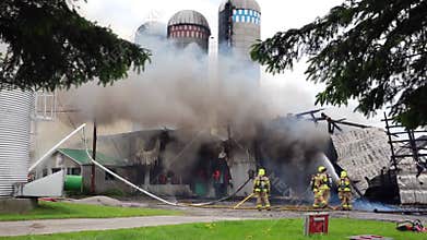 Firefighters battle silo fire.