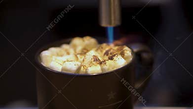 blow torch is burning fire on seasonal holiday marshmallow cocktail