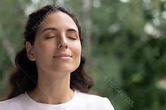Happy woman breathe fresh air dreaming with eyes closed