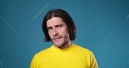Upset man shaking head in denial and pointing finger at forehead in despair