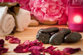 Massage stones, flowers, candles, towels.