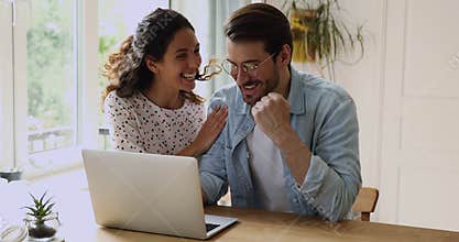 Couple check email on computer read great news celebrates success