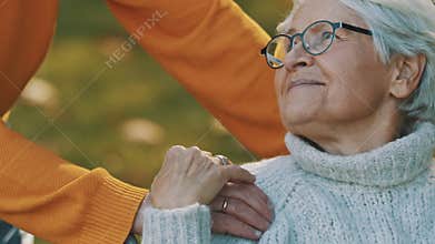Loving husband taking care of his disabled wife in the nature.