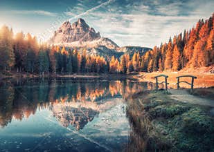 Lake with reflection in mountains at sunrise in autumn