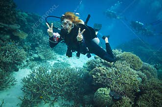 Diver flashing peace sign the Great barrier