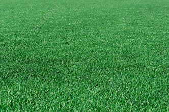 Green grass background, artificial grass on soccer field. Outdoors