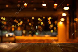 Top of wood table with bokeh of glor blur lamp light in party bar or pub in the Christmas night background