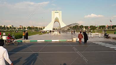 People walking in Azadi square with Azadi Tower in the Iranian capital Tehran