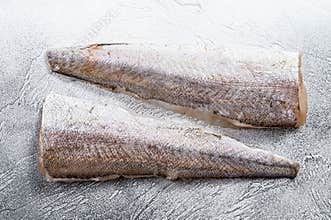 Raw fillet of hake fish. White background. Top view