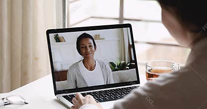 Female psychologist consulting african woman client during online counseling session