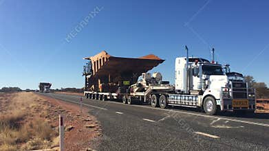 Oversized vehicle convoy on Stuart highway in central Australia Outback