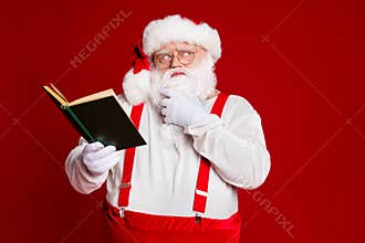 Portrait of his he attractive skeptic minded clever smart fat white-haired Santa reading book overthinking idea isolated