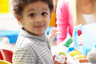 Boy playing with toys in nursery