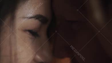 Girl stroking the face of her guy. Couple is looking at each other. Man and woman enjoy the tenderness of touch. Care