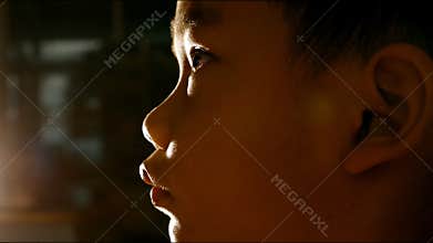 Close up face of asian children looking to television