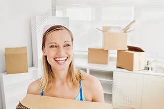 Radiant woman holding boxes