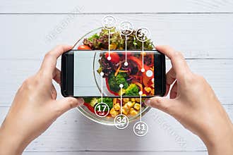Calories counting and food control concept. woman using application on smartphone for scanning the amount of calories in the food