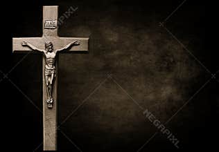 Dark mottled brown and black tones with body of Christ on wooden cross