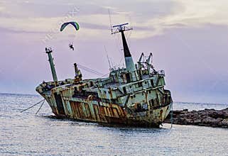 Pathos, Cyprus - May 21, 2016 - Person uses powered paraglide to circle a shipwreck