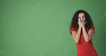 Astonished woman pointing at copy space and giving thumbs up