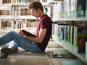 Guy studying in library