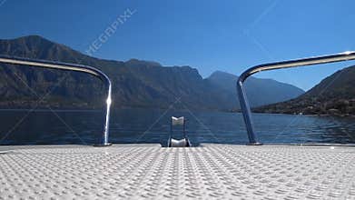 Motor boat sails on the Bay of Kotor in Montenegro. View from the bow of the boat on the mountains and the Bay of Kotor. Slow