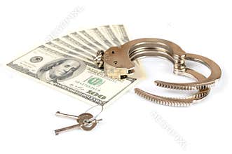Open metal handcuffs, keys and stack of american dollars cash