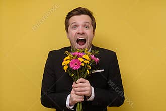 Surprised man with flowers for his girlfriend proposing to be his wife