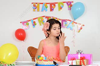 Birthday girl licking her fingers