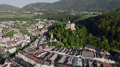 Aerial Drone shot of Brunico or Bruneck, a small town in South Tyrol. Evening time in Italian Alps Alto Adige