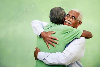 Old friends, two senior african american men meeting and hugging