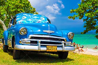 Old american car at a beach in Cuba