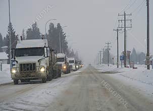 Truck convey on highway 63 Alberta  in the snow