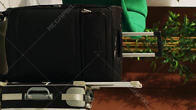 Vertical video Luggage trolley bags in hotel lobby