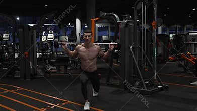 Athlete doing barbell reverse lunge in gym. Fit man exercising with barbell in fitness gym