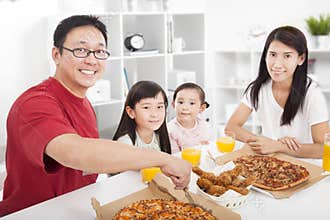 Happy Family enjoy their dinner