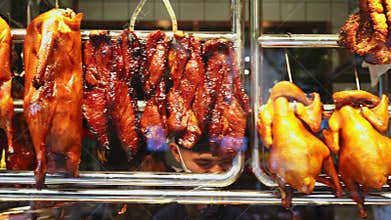 Fresh char siew and roast duck on the display window of Cantonese roast pork shop