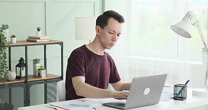 Responsible Caucasian Businessman Inputting Data into Laptop