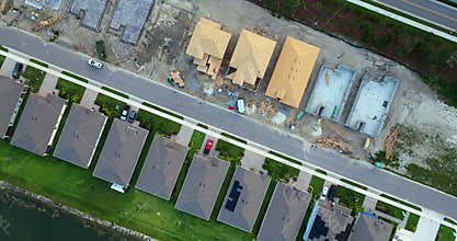 Aerial view of unfinished wooden frames of new houses under construction. Development of residential housing in American