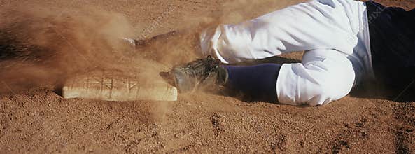 Player Sliding Towards Base On Field
