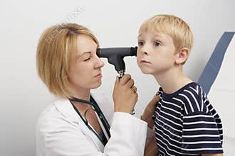 Doctor Examining Boy's Ear