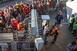 Security searches supporters at the entrance to the stadium