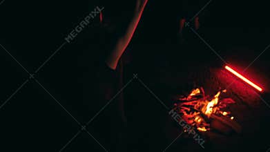 Man Dancing Near Bonfire and Red Light Bar in Ritual (High Angle).