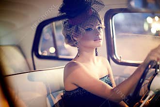 fashion girl sitting in old car