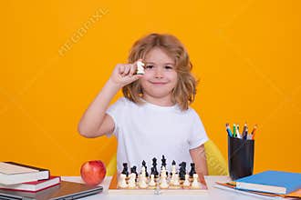 Chess for intelligent kid. Child genius, smart pupil playing logic board game. Clever school boy thinking about chess