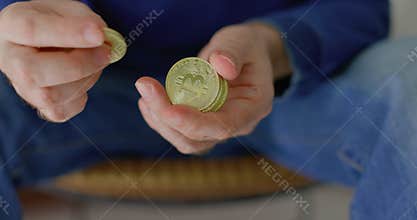 Man with some bitcoins in his hands in closeup